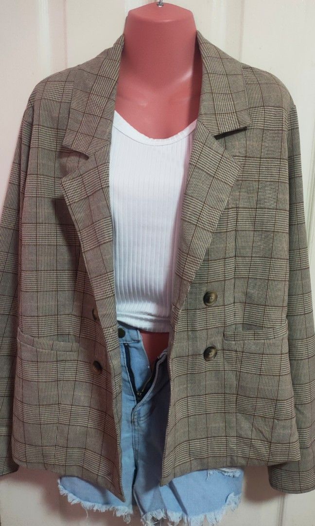 Brown Plaid Double-Breasted Blazer (Category: Coats, Jackets and Outerwear) located in Antipolo. Submitted by strawberricae (Listing ID 1464056886, Image 1). Description: - Brown plaid double-breasted blazer - Features two front pockets - Versatile for casual and smart-casual styling - Looks great layered over a white top and denim shorts.