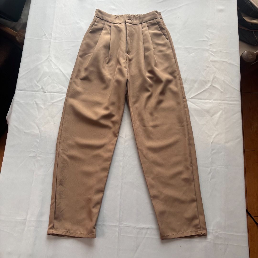 Brown Pleated High-Waisted Pants (Category: Jeans) located in Tanauan. Submitted by arlene_panganiban (Listing ID 1463999698, Image 2). Description: - High-waisted brown pants - Front pleats for a flattering look - Fabric with a slight sheen - Relaxed fit through the legs - Cuffed hem - Effortlessly dress up or down - Easy to pair with various tops.
