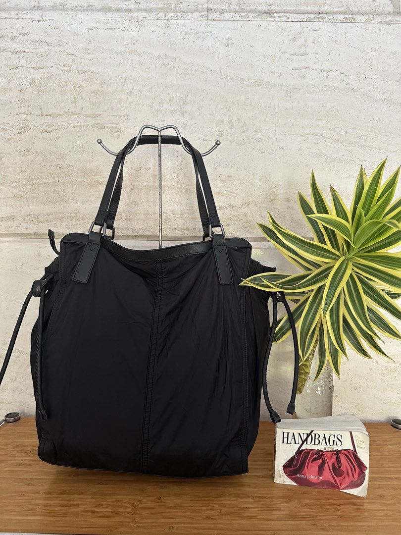 Burberry Black Nylon Leather Tote Bag (Category: Tote Bags) located in Muntinlupa City. Submitted by belica (Listing ID 1464037065, Image 3). Description: - Burberry black tote bag - Durable nylon material with elegant leather details - Iconic Burberry logo plaque on the front - Ample interior space for all your essentials - Adjustable side drawstring for a customized look - Comfortable leather handles for easy carrying - Ideal for everyday erran