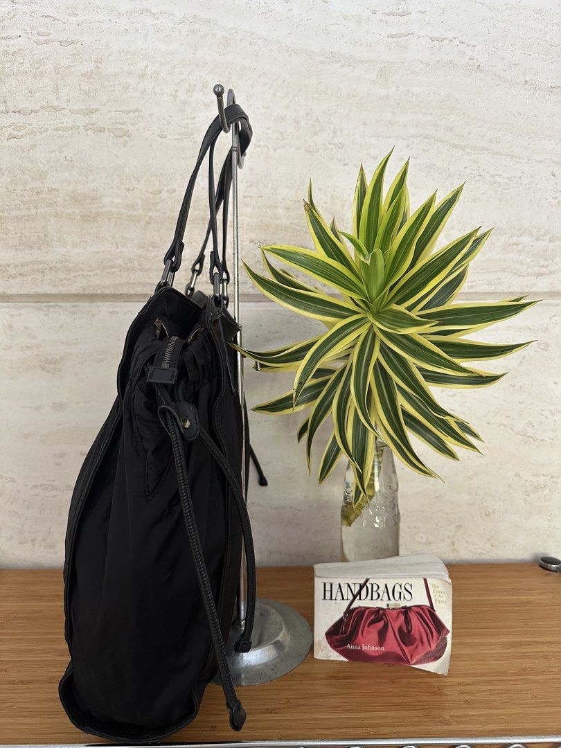 Burberry Black Nylon Leather Tote Bag (Category: Tote Bags) located in Muntinlupa City. Submitted by belica (Listing ID 1464037065, Image 2). Description: - Burberry black tote bag - Durable nylon material with elegant leather details - Iconic Burberry logo plaque on the front - Ample interior space for all your essentials - Adjustable side drawstring for a customized look - Comfortable leather handles for easy carrying - Ideal for everyday erran