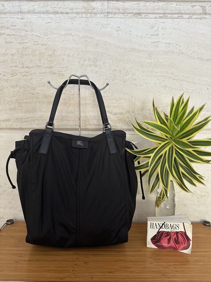 Burberry Black Nylon Leather Tote Bag (Category: Tote Bags) located in Muntinlupa City. Submitted by belica (Listing ID 1464037065, Image 1). Description: - Burberry black tote bag - Durable nylon material with elegant leather details - Iconic Burberry logo plaque on the front - Ample interior space for all your essentials - Adjustable side drawstring for a customized look - Comfortable leather handles for easy carrying - Ideal for everyday erran
