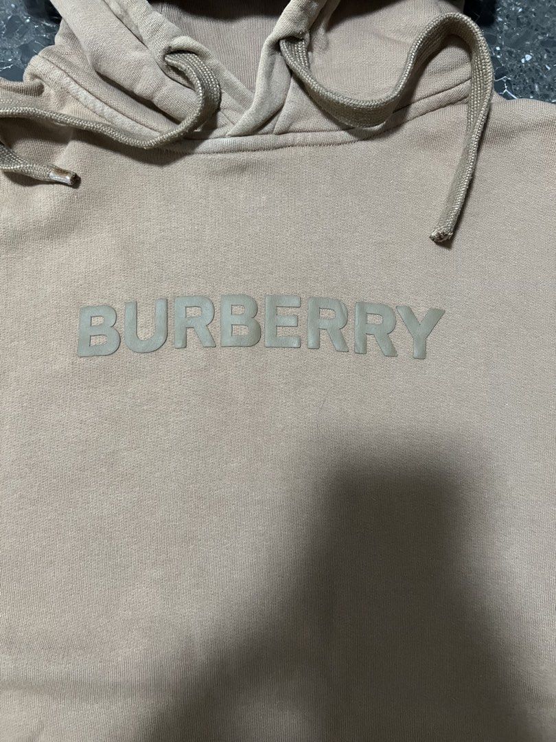 Burberry Logo Hoodie (Category: Hoodies) located in Manila. Submitted by justin_sy (Listing ID 1463983227, Image 2). Description: - Authentic Burberry hoodie - Color: Tan - Features embossed Burberry logo on chest - Material: 100% Cotton - Made in Portugal - Drawstring hood - Ideal for casual wear.