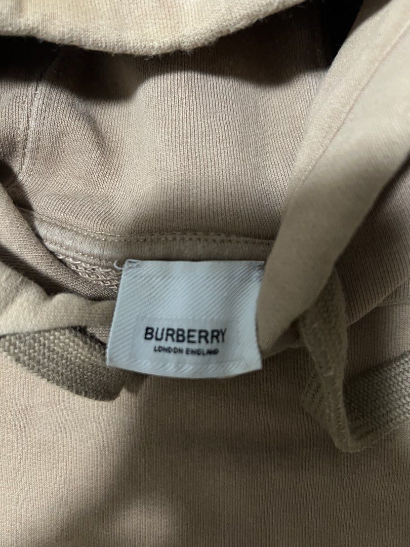 Burberry Logo Hoodie (Category: Hoodies) located in Manila. Submitted by justin_sy (Listing ID 1463983227, Image 3). Description: - Authentic Burberry hoodie - Color: Tan - Features embossed Burberry logo on chest - Material: 100% Cotton - Made in Portugal - Drawstring hood - Ideal for casual wear.