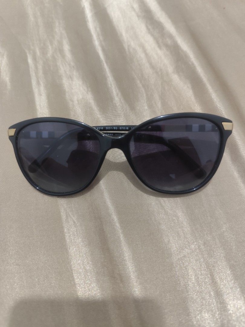 Burberry Sunglasses (Category: Sunglasses & Eyewear) located in Manila. Submitted by wildgem.7e61c6 (Listing ID 1464052247, Image 1). Description: - Authentic Burberry sunglasses - Classic shape with elegant gold accents - Signature Burberry check pattern on the arms - Dark grey gradient lenses - Minor wear on the frame near the hinge (sold as is).