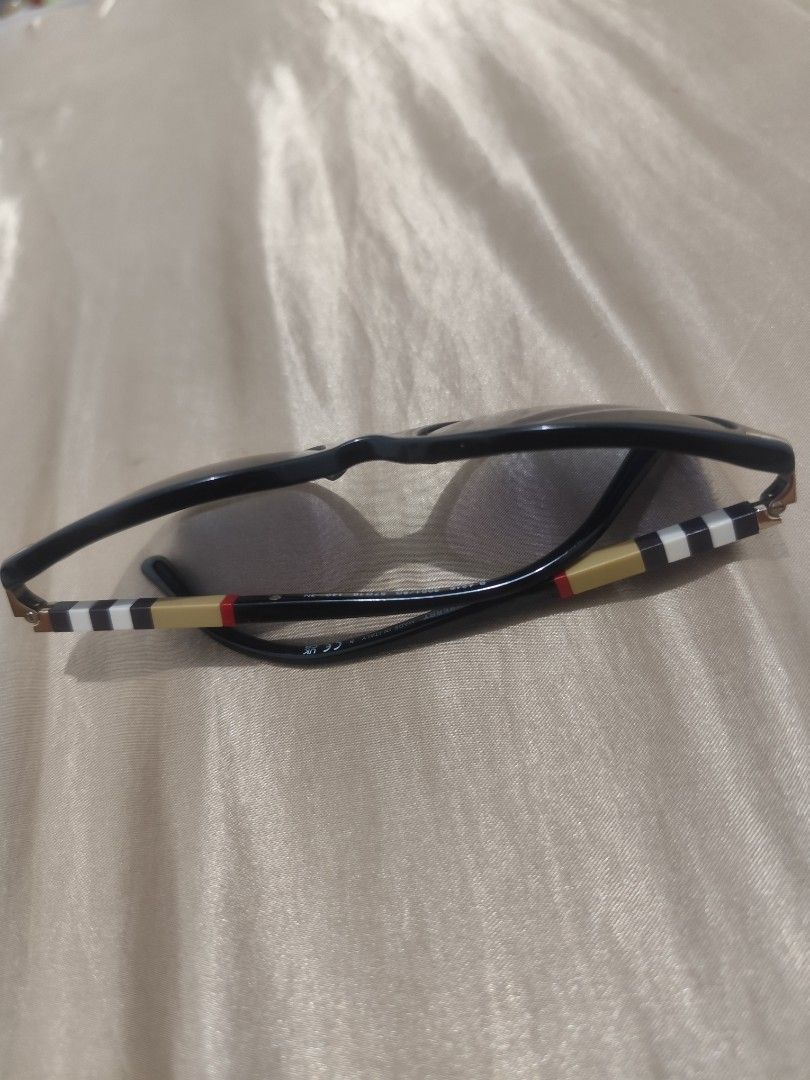Burberry Sunglasses (Category: Sunglasses & Eyewear) located in Manila. Submitted by wildgem.7e61c6 (Listing ID 1464052247, Image 3). Description: - Authentic Burberry sunglasses - Classic shape with elegant gold accents - Signature Burberry check pattern on the arms - Dark grey gradient lenses - Minor wear on the frame near the hinge (sold as is).