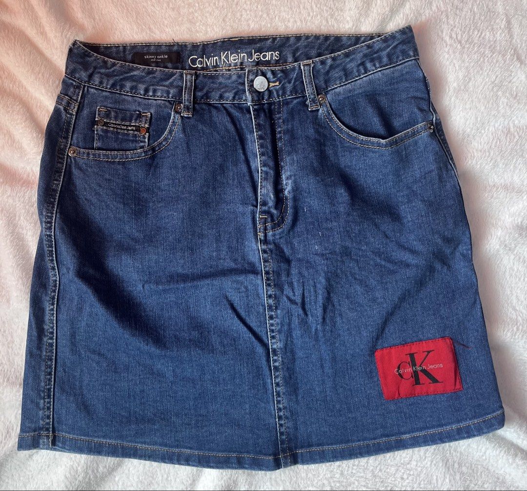 Calvin Klein Jeans Denim Skirt with Red Logo Patch (Category: Skirts) located in Cabuyao City. Submitted by jei_gspr (Listing ID 1463955006, Image 1). Description: - Classic blue denim skirt from Calvin Klein Jeans - Iconic red CK logo patch on the front - Button and zip closure - Standard five-pocket styling - Versatile piece, pairs well with t-shirts or sweaters.