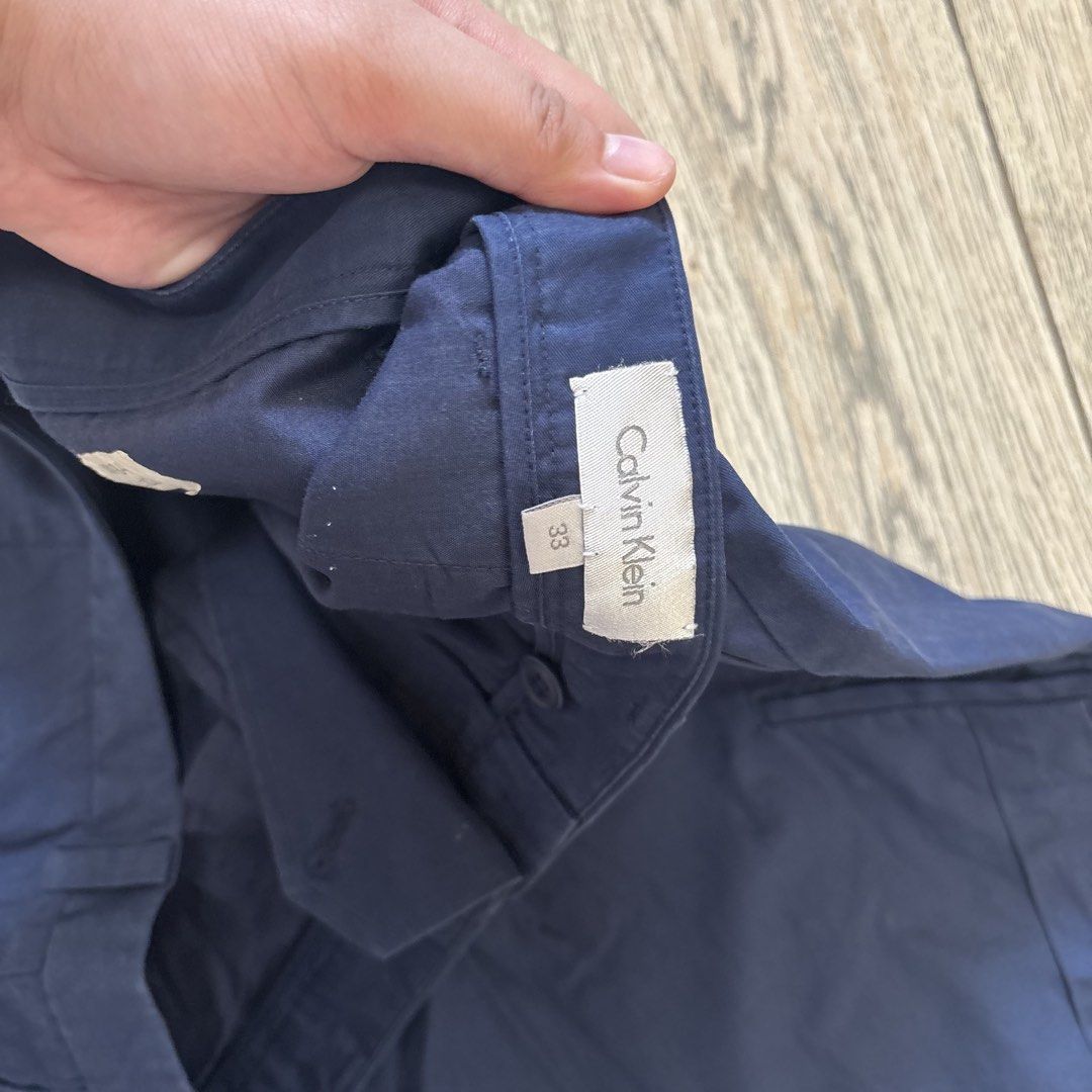 Calvin Klein Navy Blue Cargo Shorts (Category: Shorts) located in Imus. Submitted by reloved.nd (Listing ID 1464071696, Image 2). Description: - Navy blue Calvin Klein cargo shorts - Size 33 - Classic cargo style with side pockets - Comfortable fit for everyday wear - Perfect for casual outings.