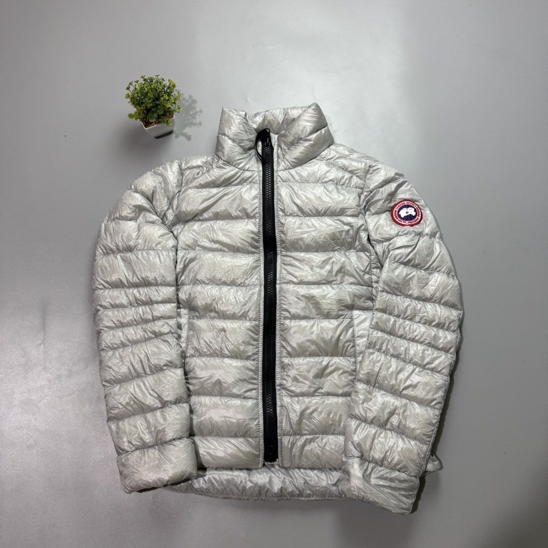 Canada Goose Puffer Jacket - Silver (Category: Coats, Jackets and Outerwear) located in Bago City. Submitted by g___shop (Listing ID 1464047036, Image 1). Description: - Shiny silver Canada Goose puffer jacket - Zip-up front with a stand-up collar - Lightweight and warm, ideal for cooler weather - Signature Canada Goose patch on the sleeve.