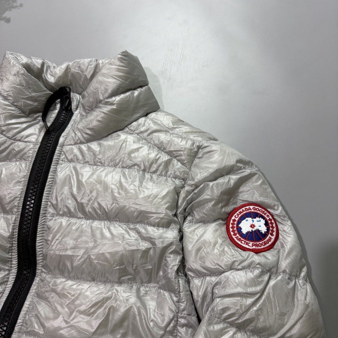 Canada Goose Puffer Jacket - Silver (Category: Coats, Jackets and Outerwear) located in Bago City. Submitted by g___shop (Listing ID 1464047036, Image 2). Description: - Shiny silver Canada Goose puffer jacket - Zip-up front with a stand-up collar - Lightweight and warm, ideal for cooler weather - Signature Canada Goose patch on the sleeve.