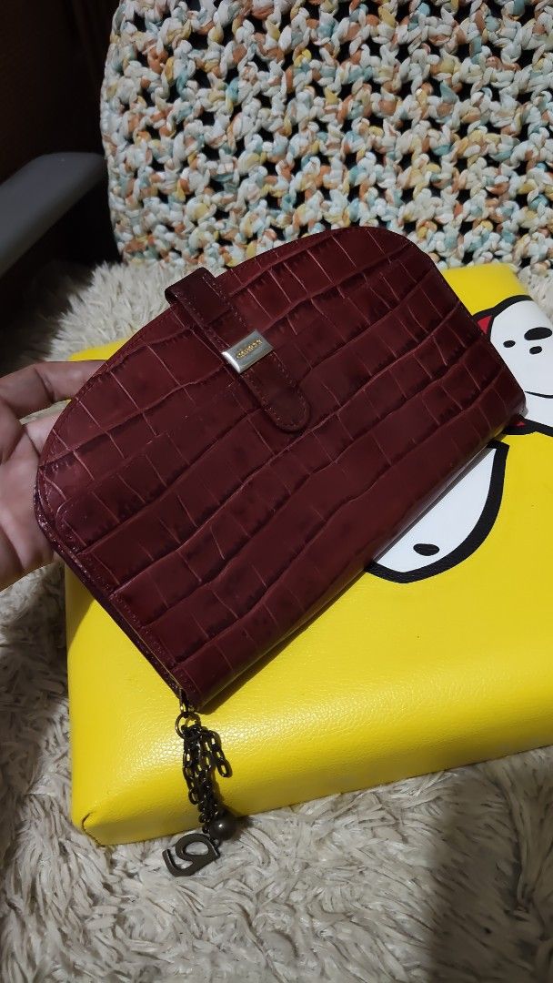Capacci Croc Embossed Leather Wallet (Category: Wallets & Card holders) located in Cebu City. Submitted by lumaynojes00490 (Listing ID 1463965320, Image 1). Description: - Rich deep red color - Luxurious croc-embossed leather - Secure snap closure - Signature small metal logo detail - Decorative chain charm attached to zipper - Spacious interior for cards and cash - Classic and elegant design.