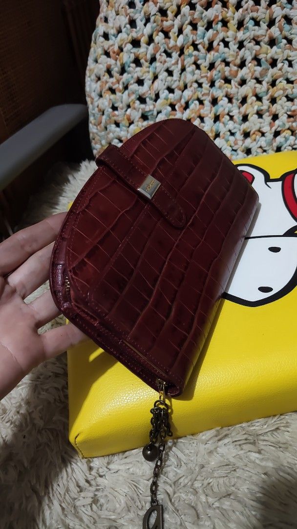 Capacci Croc Embossed Leather Wallet (Category: Wallets & Card holders) located in Cebu City. Submitted by lumaynojes00490 (Listing ID 1463965320, Image 2). Description: - Rich deep red color - Luxurious croc-embossed leather - Secure snap closure - Signature small metal logo detail - Decorative chain charm attached to zipper - Spacious interior for cards and cash - Classic and elegant design.