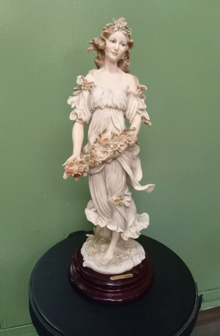 Capodimonte Lady with Flowers Figurine (Category: Figurines & Statues) located in Makati City. Submitted by rnst1 (Listing ID 1463958987, Image 1). Description: - Exquisite Capodimonte figurine of a lady holding flowers. - Features intricate details on her dress and hair. - Elegant base with a rich wood finish. - Adds a classic touch to any home decor. - Perfect for collectors or as a special gift. - Approximate height: [insert height here] inche