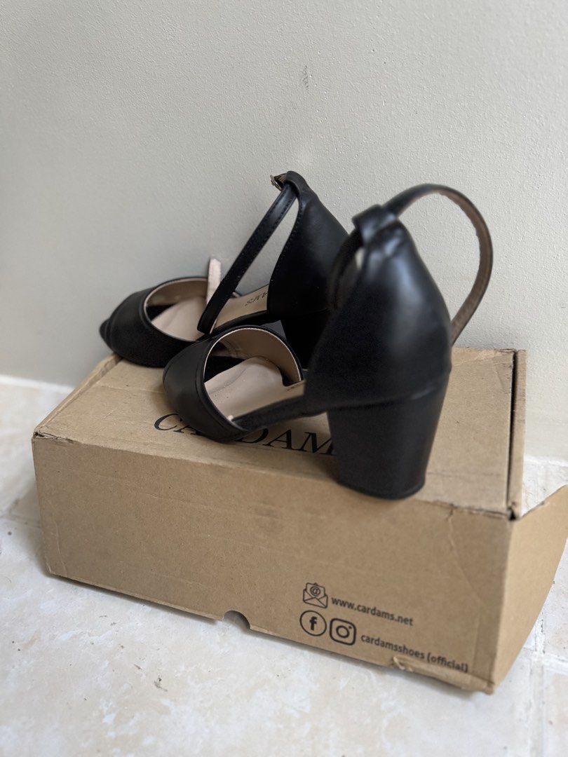 Cardam's Black Peep-Toe Ankle Strap Heels (Category: Heels) located in Cavite. Submitted by araja____7 (Listing ID 1463973512, Image 2). Description: - Brand: Cardam's - Style: Black peep-toe heels - Features: Ankle strap with buckle closure, comfortable block heel - Versatile: Perfect for dressing up or down - Condition: Comes with original box.