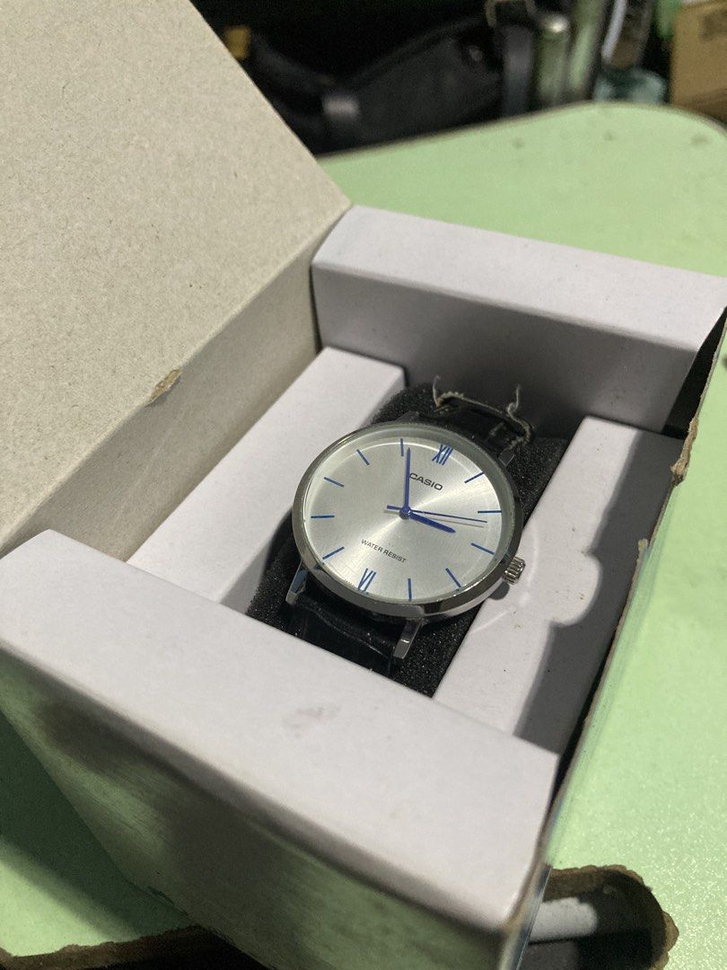 Casio Watch Silver Face Black Leather Strap (Category: Women's Watches) located in Pasig City. Submitted by alaincainglet (Listing ID 1464082076, Image 2). Description: - Casio Watch - Elegant silver dial with striking blue hands - Comfortable black leather strap with a sophisticated crocodile texture - Water resistant for everyday wear - Durable stainless steel back - Comes with its original box.