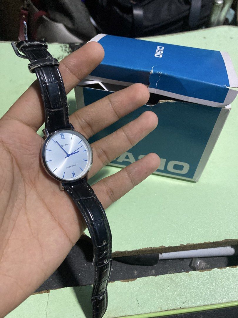 Casio Watch Silver Face Black Leather Strap (Category: Women's Watches) located in Pasig City. Submitted by alaincainglet (Listing ID 1464082076, Image 1). Description: - Casio Watch - Elegant silver dial with striking blue hands - Comfortable black leather strap with a sophisticated crocodile texture - Water resistant for everyday wear - Durable stainless steel back - Comes with its original box.