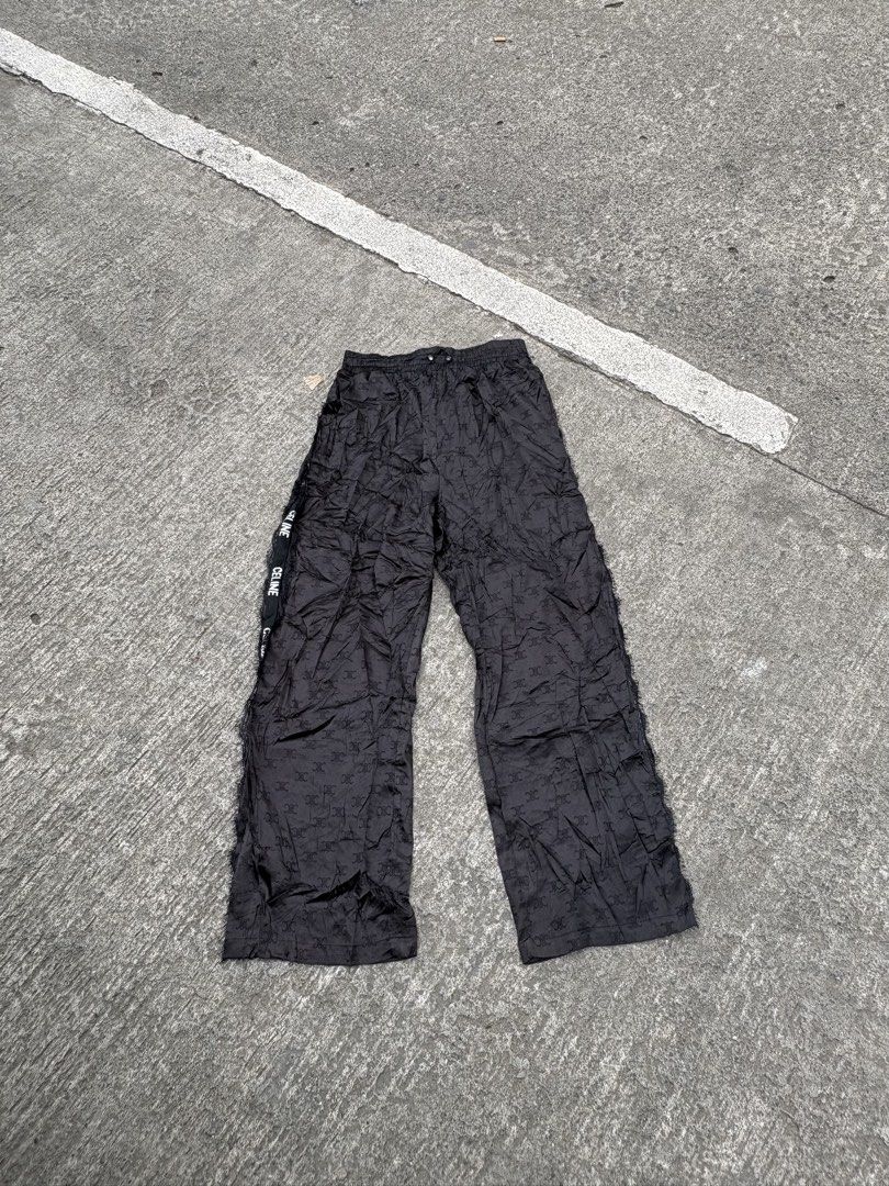 CELINE Black Monogram Track Pants Size L (Category: Other Bottoms) located in Iligan City. Submitted by seddicmoti2002 (Listing ID 1463982940, Image 1). Description: - Brand: CELINE -Wide leg - Stretchable - Color: Black - Design: All-over monogram pattern - Features: CELINE branded tape down the sides, elastic waistband - Material: 100% Nylon - Size: L (fits 165/88A).
