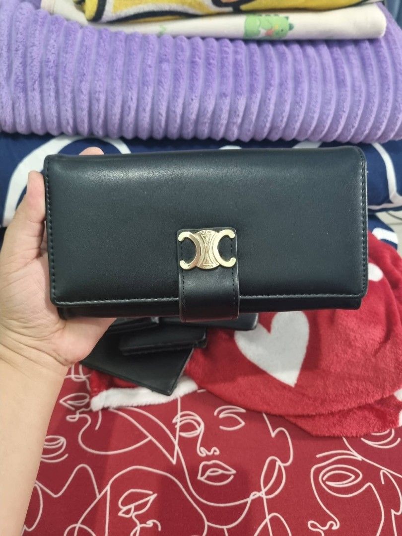 Celine Triomphe Wallet Black Leather (Category: Luxury Bags & Wallets) located in Candon. Submitted by bernabepradoiii (Listing ID 1463939667, Image 1). Description: - Genuine black leather wallet - Iconic Celine Triomphe logo in gold hardware - Secure snap closure - Ample card slots for organization - Interior zip pocket for coins or small items - Stylish and practical for everyday use.
