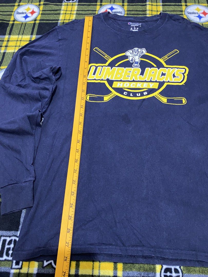 CHAMPION,long sleeve shirt (Category: Coats, Jackets and Outerwear) located in Cavite. Submitted by jc_thrift95 (Listing ID 1464093142, Image 2). Description: - a navy blue Champion long-sleeve t-shirt featuring a prominent yellow Lumberjacks Hockey Club graphic on the chest. - Made in Nicaragua - Color rate 8/10 - See pictures details for dimes..