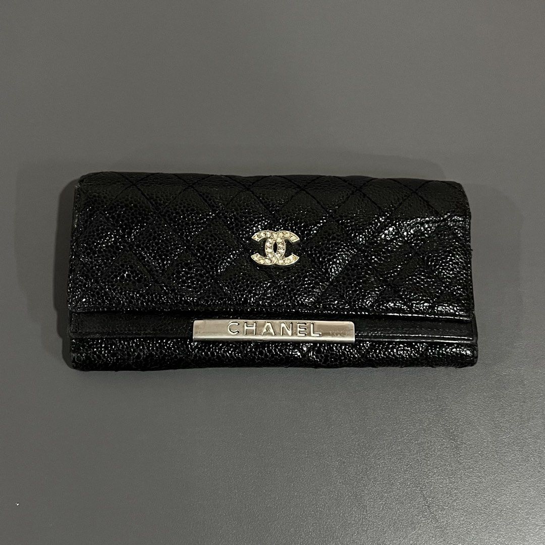Chanel Black Caviar Leather Long Wallet (Category: Wallets & Card holders) located in M'Lang. Submitted by alexpabillo0324 (Listing ID 1464035811, Image 1). Description: - Authentic Chanel Long Wallet - Material: Black Caviar Leather - Design: Classic quilted pattern - Hardware: Silver Chanel logo - Interior: Vibrant purple lining - Features: Multiple card slots, zippered compartment - Authenticity: Serial number sticker included - Benefit: Perfe