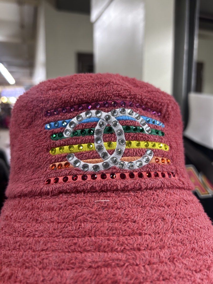 Chanel Bucket Hat with Rainbow Rhinestone CC Logo (Category: Hats & Beanies) located in Pasig City. Submitted by blitzkriegspc (Listing ID 1464136430, Image 2). Description: - Pink textured bucket hat - Features iconic Chanel CC logo - Embellished with colorful rainbow rhinestones - Adds a unique pop of color to any outfit - Great for stylish everyday wear.