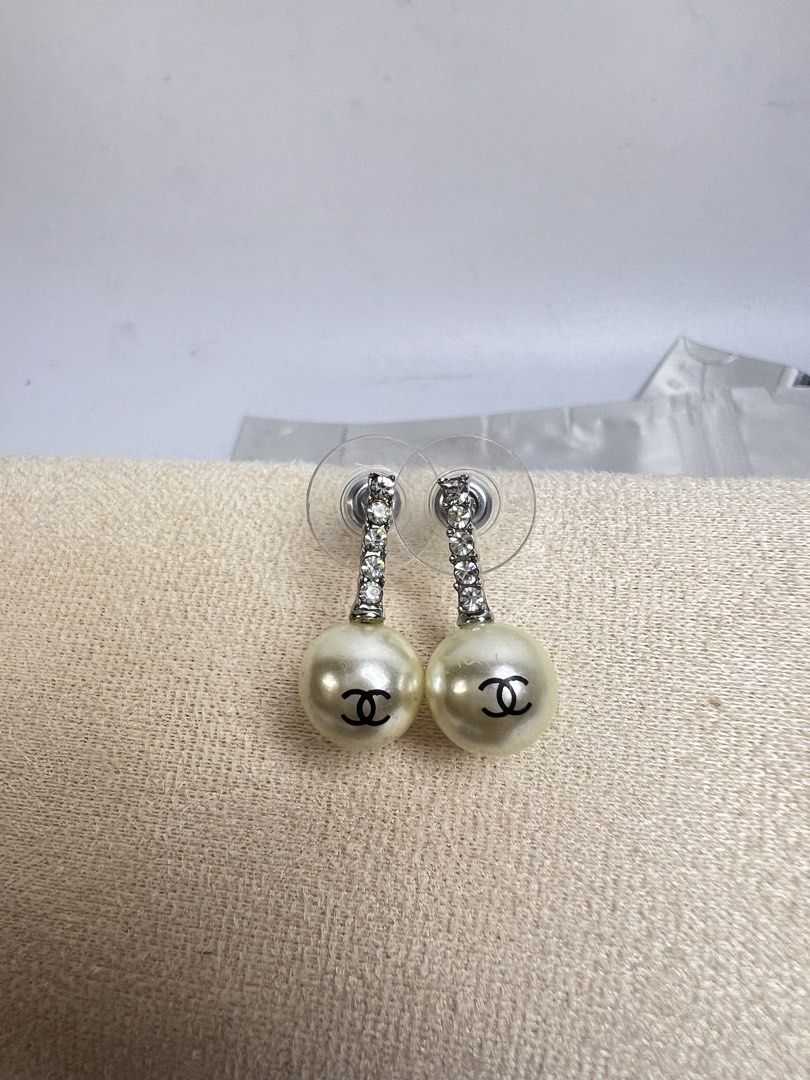 Chanel Pearl Drop Earrings with Crystals (Category: Earrings) located in Baguio. Submitted by chiechie1234 (Listing ID 1463982625, Image 1). Description: - Classic Chanel pearl drop earrings - Features iconic CC logo on pearls - Accented with sparkling crystal studs - Elegant and timeless design - Perfect for elevating any outfit - A must-have for fashion enthusiasts.