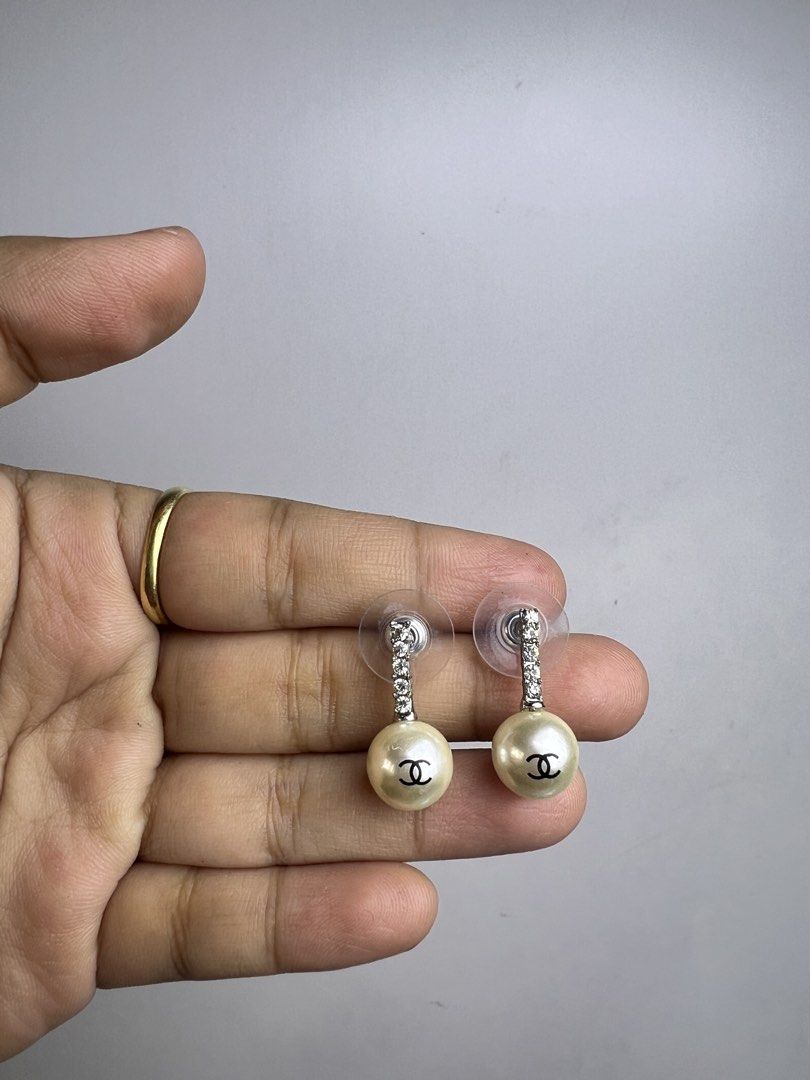 Chanel Pearl Drop Earrings with Crystals (Category: Earrings) located in Baguio. Submitted by chiechie1234 (Listing ID 1463982625, Image 3). Description: - Classic Chanel pearl drop earrings - Features iconic CC logo on pearls - Accented with sparkling crystal studs - Elegant and timeless design - Perfect for elevating any outfit - A must-have for fashion enthusiasts.