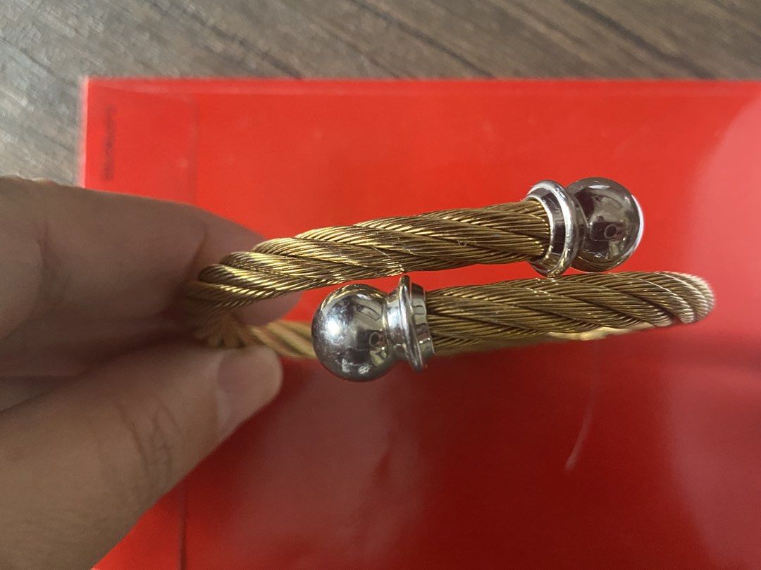 Chariol Gold Twisted Cable Bangle Bracelet with Silver Caps (Category: Bracelets) located in Quezon City. Submitted by jiujitsu_la (Listing ID 1463964991, Image 1). Description: - Gold twisted cable cuff bracelet - Features silver ball caps on each end - Stylish statement piece - Perfect for wearing solo or stacking with other bracelets - Adds a touch of elegance to any outfit Markdown from 8000 to 7500.