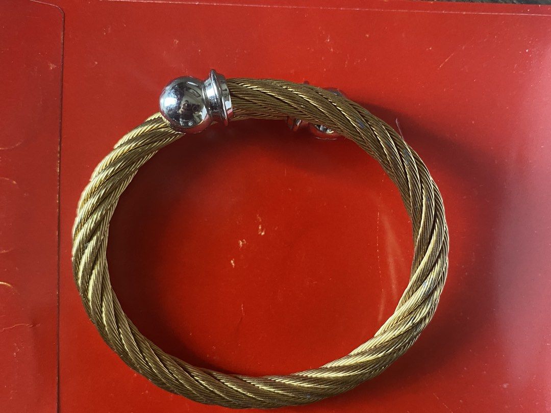 Chariol Gold Twisted Cable Bangle Bracelet with Silver Caps (Category: Bracelets) located in Quezon City. Submitted by jiujitsu_la (Listing ID 1463964991, Image 2). Description: - Gold twisted cable cuff bracelet - Features silver ball caps on each end - Stylish statement piece - Perfect for wearing solo or stacking with other bracelets - Adds a touch of elegance to any outfit Markdown from 8000 to 7500.