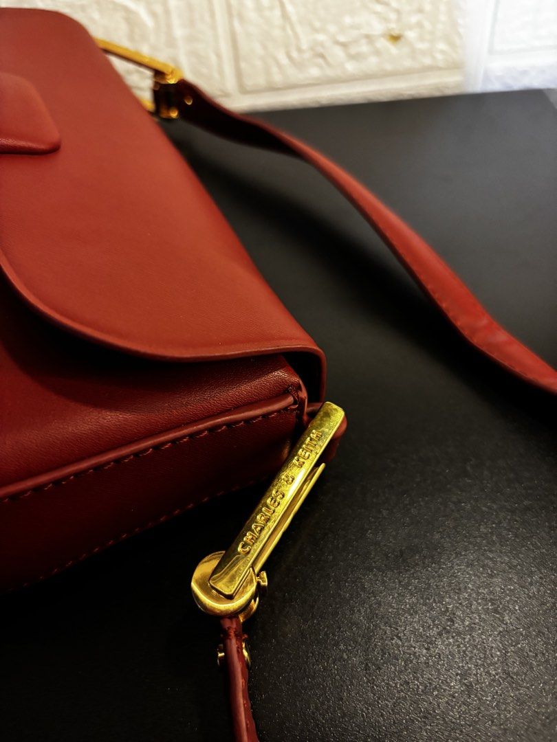 Charles & Keith Burgundy Shoulder Bag (Category: Shoulder Bags) located in Caloocan City. Submitted by _avionlineshop24 (Listing ID 1464137744, Image 2). Description: - Burgundy shoulder bag by Charles & Keith - Elegant gold hardware details - zip compartment for secure storage - Front flap closure for added style - Clean and well-maintained interior - Versatile: ideal for daily use or evening events.