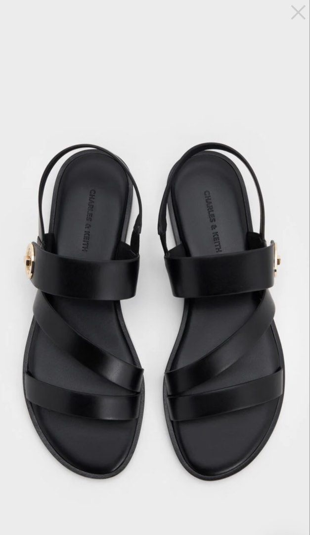 Charles & Keith Sandals (Category: Flats & Sandals) located in Cabanatuan. Submitted by scrlttt (Listing ID 1464076060, Image 2). Description: - Brand: Charles & Keith - Color: Black - Style: Strappy sandals - Features: Turn lock detail on side strap, comfortable flat sole - Design: Easy slip-on - Versatility: Great for casual outings or dressing up - Original Price: P3,199.00.