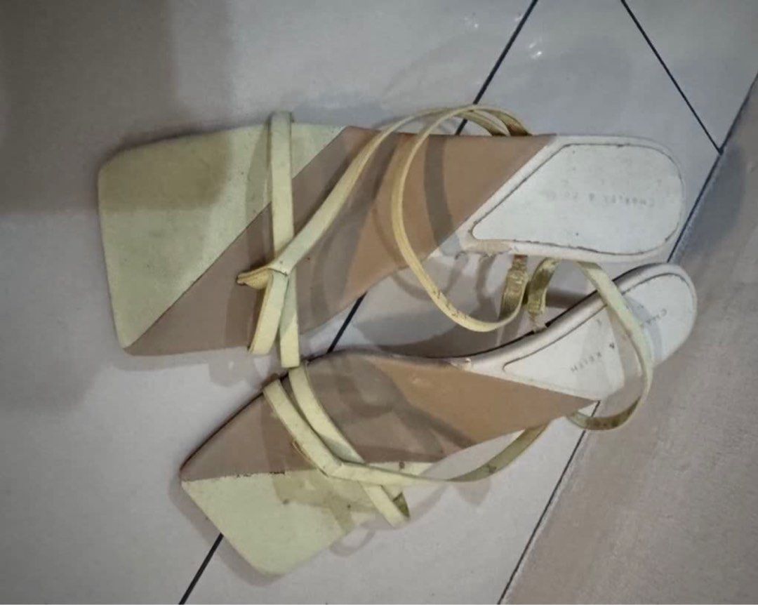 Charles & Keith Strappy Square Toe Heels (Category: Heels) located in Manila. Submitted by decluterthings888 (Listing ID 1464031535, Image 1). Description: - Brand: Charles & Keith - Style: Strappy heels with square toe - Color: Color block (Beige and Light Yellow) - Heel height: Low (easy to walk in) - Condition: Shows some signs of wear on soles and straps - Perfect for: Casual outings.
