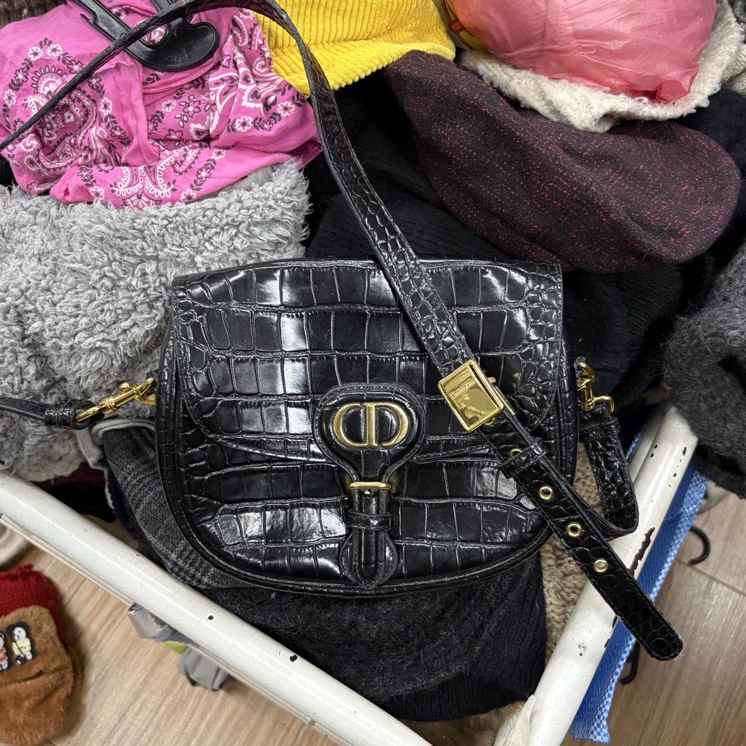 Christian Dior Black Croc Embossed Bobby Bag (Category: Luxury Bags & Wallets) located in Zamboanga. Submitted by thriftyyali (Listing ID 1464036568, Image 1). Description: - Authentic Christian Dior shoulder bag - Luxurious black croc-embossed leather - Elegant gold-tone hardware with signature CD logo clasp - Adjustable strap for comfortable wear - Expertly crafted in Italy - Shows some signs of wear on hardware and strap, adding character.