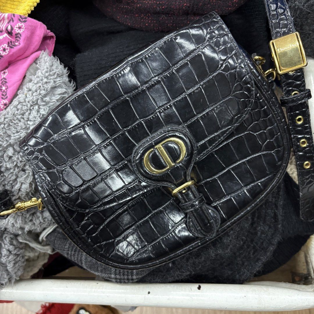 Christian Dior Black Croc Embossed Bobby Bag (Category: Luxury Bags & Wallets) located in Zamboanga. Submitted by thriftyyali (Listing ID 1464036568, Image 2). Description: - Authentic Christian Dior shoulder bag - Luxurious black croc-embossed leather - Elegant gold-tone hardware with signature CD logo clasp - Adjustable strap for comfortable wear - Expertly crafted in Italy - Shows some signs of wear on hardware and strap, adding character.