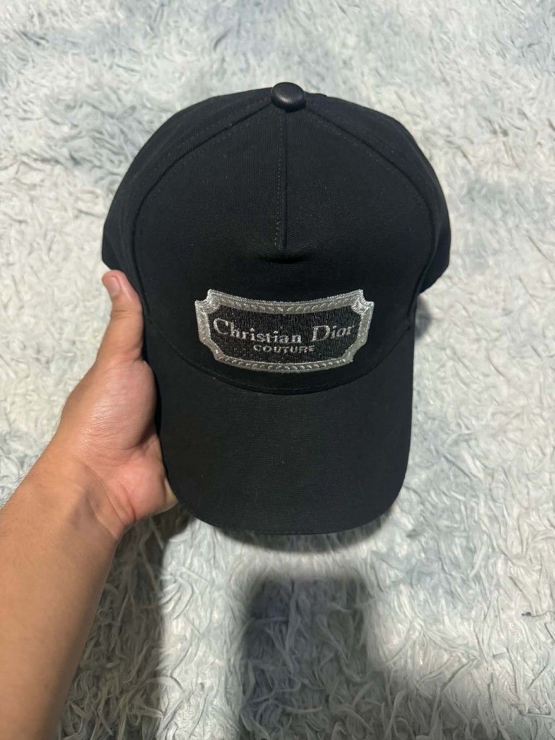 Christian Dior Couture Black Baseball Cap (Category: Caps & Hats) located in Manila. Submitted by thriftyboyzzz (Listing ID 1464062636, Image 3). Description: - Authentic Christian Dior cap - Features 'Christian Dior Couture' embroidered logo - Adjustable strap with metal buckle for a custom fit - Classic baseball cap style - Perfect for everyday wear.
