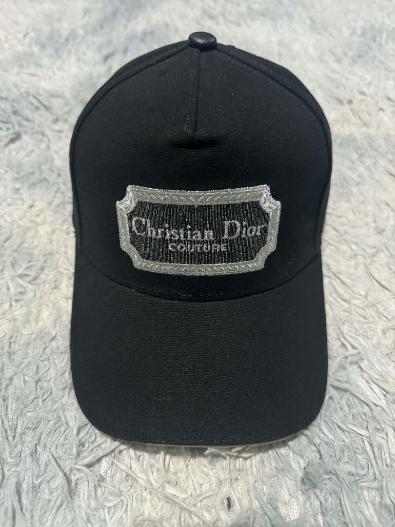 Christian Dior Couture Black Baseball Cap (Category: Caps & Hats) located in Manila. Submitted by thriftyboyzzz (Listing ID 1464062636, Image 1). Description: - Authentic Christian Dior cap - Features 'Christian Dior Couture' embroidered logo - Adjustable strap with metal buckle for a custom fit - Classic baseball cap style - Perfect for everyday wear.