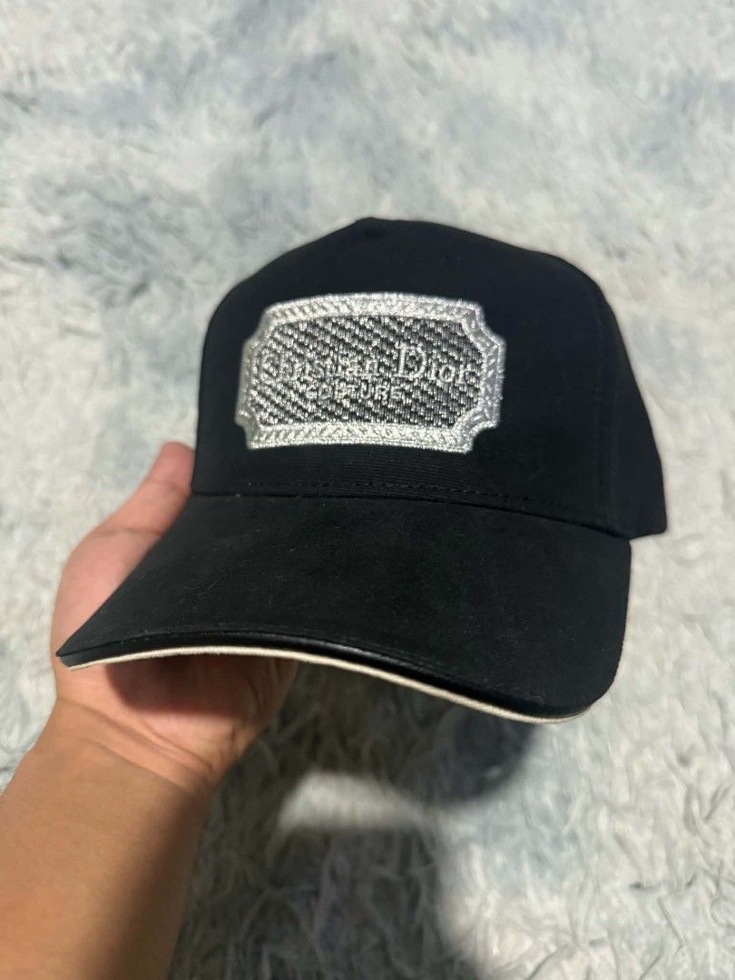 Christian Dior Couture Black Baseball Cap (Category: Caps & Hats) located in Manila. Submitted by thriftyboyzzz (Listing ID 1464062636, Image 2). Description: - Authentic Christian Dior cap - Features 'Christian Dior Couture' embroidered logo - Adjustable strap with metal buckle for a custom fit - Classic baseball cap style - Perfect for everyday wear.