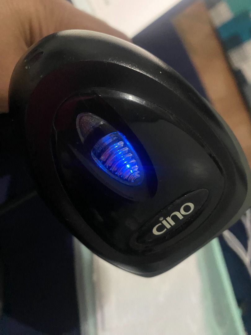Cino Barcode Scanner (Category: Office & Business Technology) located in Taguig. Submitted by azil16 (Listing ID 1464073320, Image 2). Description: - Brand: Cino - Type: Handheld Barcode Scanner - Indicator: Blue light shows it's powered on - Condition: Works well, ready to use - Ideal for: Inventory management, Point of Sale (POS) systems - Includes: USB cable.