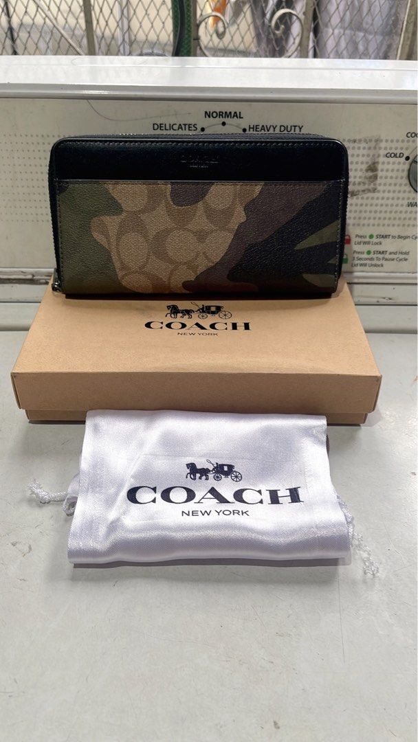 Coach Camo Zip Around Wallet with Box and Pouch (Category: Wallets & Card holders) located in Quezon City. Submitted by donnabelle7572 (Listing ID 1463946132, Image 1). Description: - Authentic Coach wallet with stylish camouflage print. - Secure zip-around closure. - Includes original Coach box and dust pouch. - Ideal for keeping your essentials neatly organized. - Zipper pull features the iconic Coach logo. - A great accessory to complement you