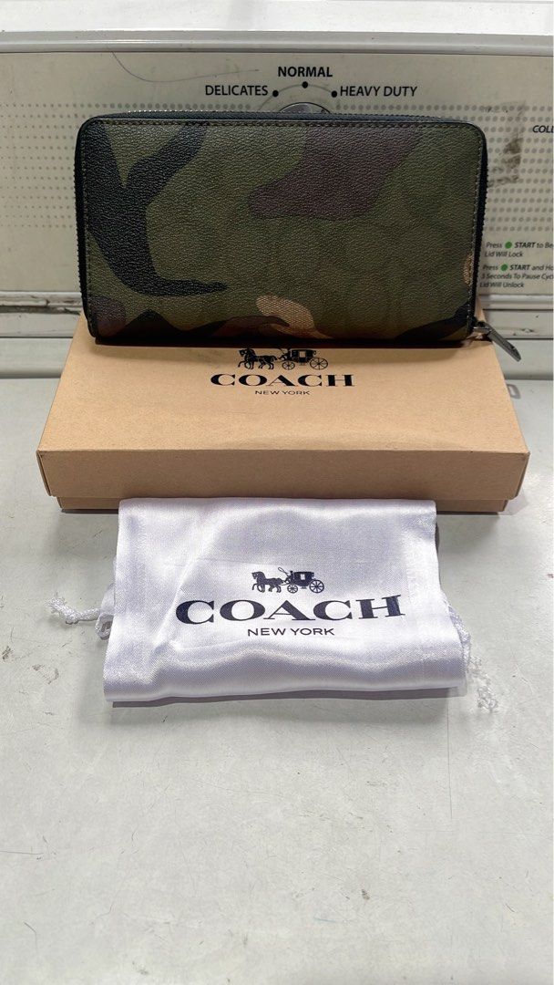 Coach Camo Zip Around Wallet with Box and Pouch (Category: Wallets & Card holders) located in Quezon City. Submitted by donnabelle7572 (Listing ID 1463946132, Image 2). Description: - Authentic Coach wallet with stylish camouflage print. - Secure zip-around closure. - Includes original Coach box and dust pouch. - Ideal for keeping your essentials neatly organized. - Zipper pull features the iconic Coach logo. - A great accessory to complement you