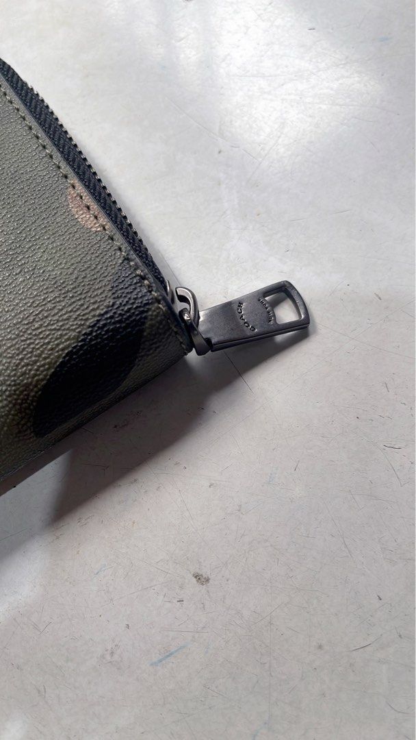 Coach Camo Zip Around Wallet with Box and Pouch (Category: Wallets & Card holders) located in Quezon City. Submitted by donnabelle7572 (Listing ID 1463946132, Image 3). Description: - Authentic Coach wallet with stylish camouflage print. - Secure zip-around closure. - Includes original Coach box and dust pouch. - Ideal for keeping your essentials neatly organized. - Zipper pull features the iconic Coach logo. - A great accessory to complement you