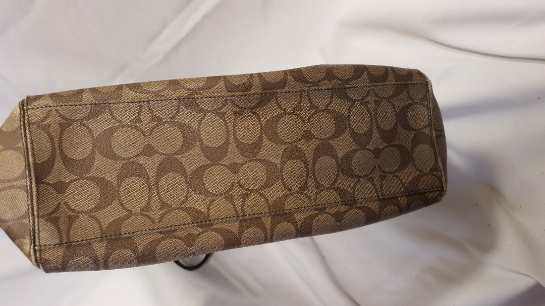 Coach Monogram Canvas Leather Trim Tote Bag (Category: Luxury Bags & Wallets) located in Pasig City. Submitted by angel025 (Listing ID 1464124717, Image 3). Description: - Classic Coach monogram tote - Color: Brown canvas with black leather trim and handles - Spacious interior for essentials - Includes an inside zippered pocket - Silver hardware details - Ideal for everyday use - like new.