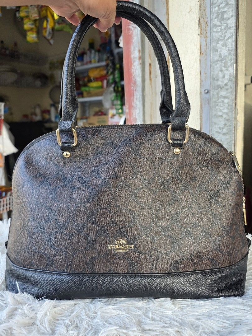 Coach Monogram Dome Satchel Handbag (Category: Luxury Bags & Wallets) located in Agoncillo. Submitted by vinsoy07 (Listing ID 1463990756, Image 1). Description: - Coach monogram dome satchel - Color: Brown and black - Material: Leather trim and handles - Hardware: Gold-tone - Closure: Zipper - Style: Classic and timeless.
