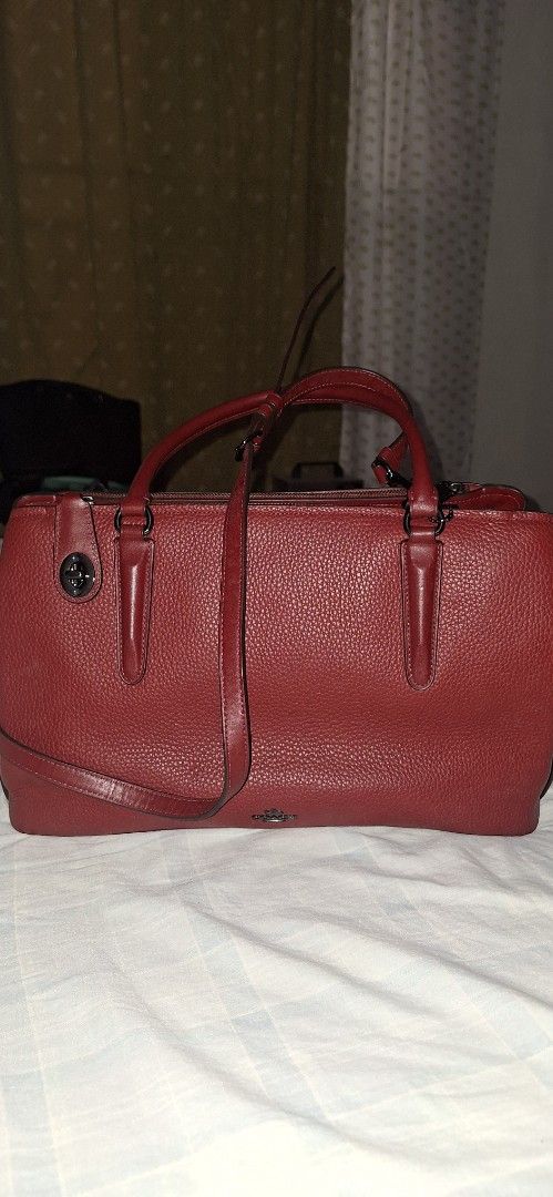 Coach Red Leather Satchel Handbag (Category: Luxury Bags & Wallets) located in Dasmarinas. Submitted by jdc3173 (Listing ID 1464053387, Image 2). Description: - Authentic red Coach satchel - Made of premium pebbled leather - Versatile with top handles and a detachable strap - Interior zip pocket for organization - Coach creed patch for authenticity - Protective metal feet on the bottom - Comes with original Coach hang tag.