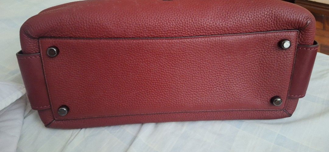 Coach Red Leather Satchel Handbag (Category: Luxury Bags & Wallets) located in Dasmarinas. Submitted by jdc3173 (Listing ID 1464053387, Image 3). Description: - Authentic red Coach satchel - Made of premium pebbled leather - Versatile with top handles and a detachable strap - Interior zip pocket for organization - Coach creed patch for authenticity - Protective metal feet on the bottom - Comes with original Coach hang tag.