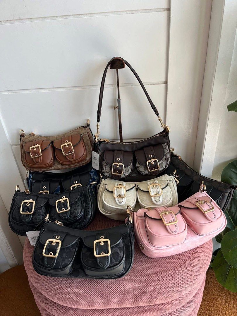 Coach Shoulder Bag with Double Front Pockets (Category: Shoulder Bags) located in Manila. Submitted by jsvdhs (Listing ID 1464083849, Image 1). Description: - Coach shoulder bag with iconic signature C print - Two front pockets with secure buckle closures - Versatile carrying options: long adjustable strap and shorter handle - Available in stylish colors: brown, black, pink, and cream - Elegant gold hardware details - Ideal for everyday wear and 