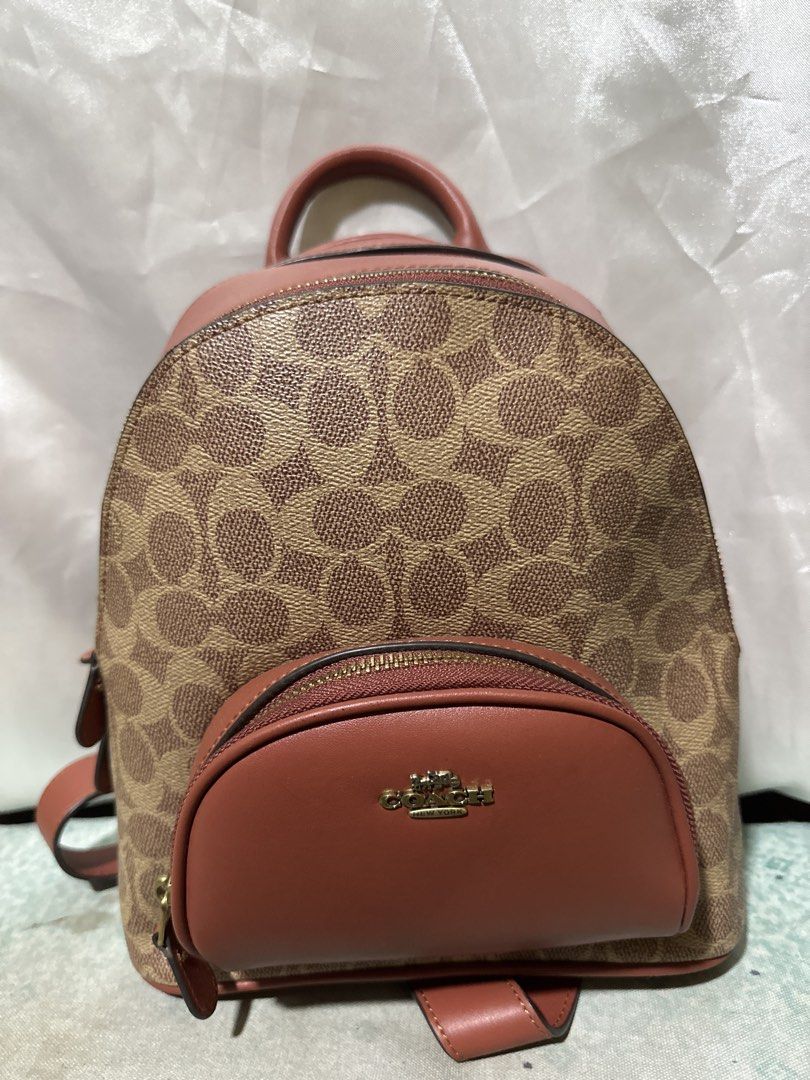 Coach Signature Canvas & Leather Backpack (Category: Backpacks) located in Balanga. Submitted by jk2025. (Listing ID 1463952187, Image 1). Description: - Authentic Coach backpack - Signature canvas and brown leather - Front zip pocket with Coach New York logo - Top handle - Adjustable shoulder straps - Perfect for daily use or travel - Clean inside and out - Ready for a new owner.