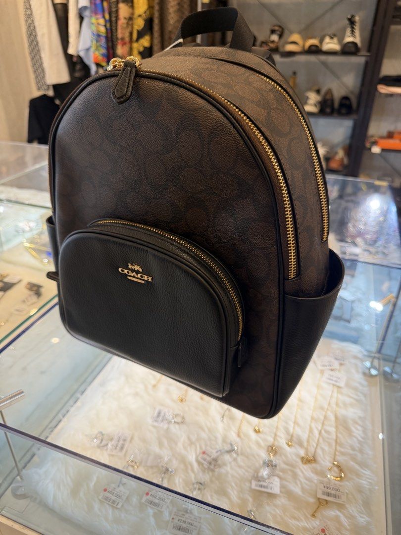 Coach Signature Monogram Backpack Brown Black (Category: Backpacks) located in Manila. Submitted by arcietan02437 (Listing ID 1464088217, Image 2). Description: - Classic Coach backpack - Brown signature monogram canvas - Black leather trim - Gold hardware - Front zip pocket - Side pockets - Spacious interior - Ideal for everyday use or travel.