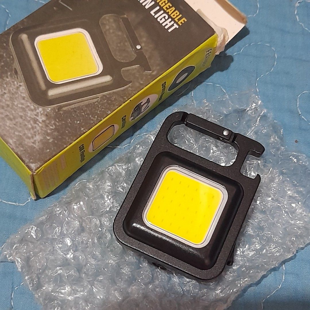 COB Rechargeable Keychain Light with Carabiner (Category: Lighting) located in Bocaue. Submitted by marajapansurplus (Listing ID 1463974388, Image 2). Description: - Super bright COB light - Rechargeable via USB - Built-in carabiner clip for easy attachment - Magnetic base for hands-free use - Ideal for camping, emergencies, and everyday carry (EDC) - Comes with USB charging cable.