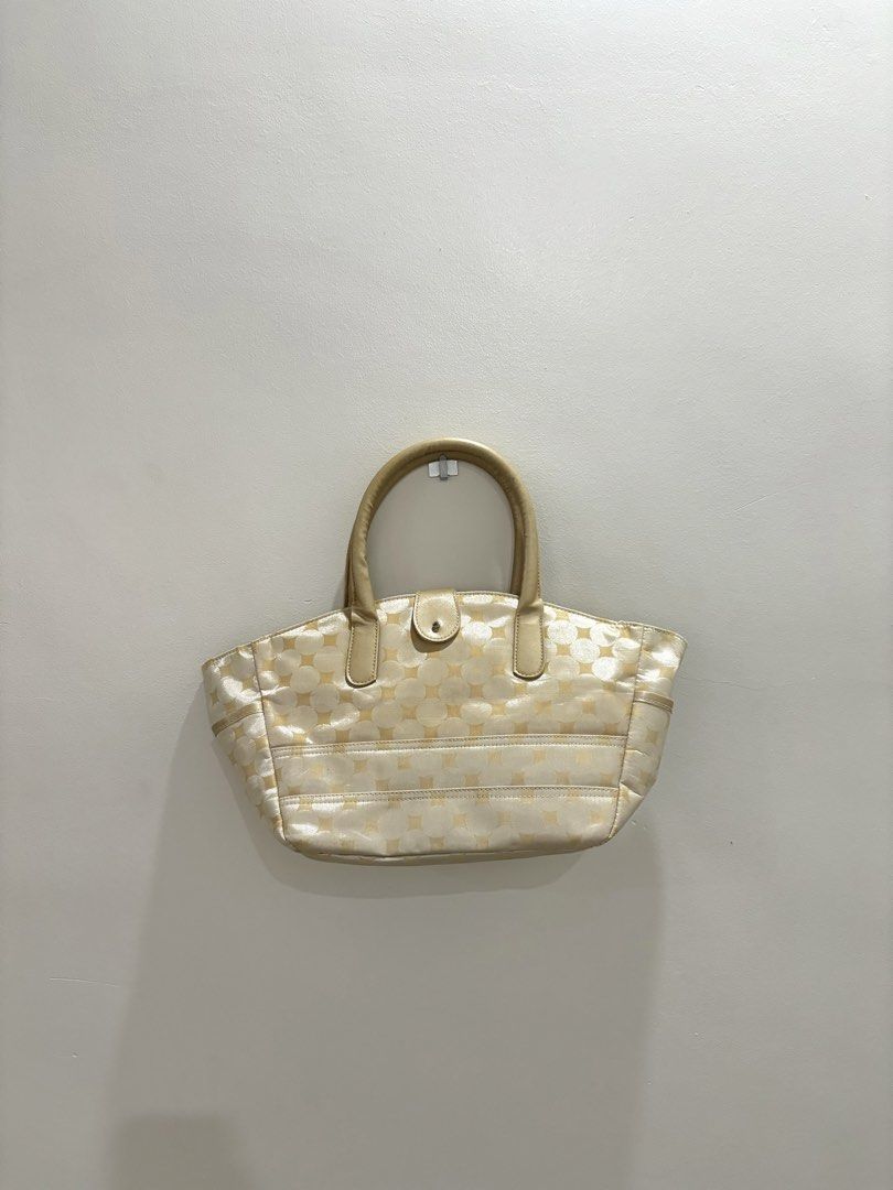 Cream & Gold Patterned Tote Bag with Floral Lining (Category: Tote Bags) located in Bulacan. Submitted by janeeeeelleeeee (Listing ID 1464121749, Image 1). Description: - Cream colored tote bag - Repeating gold starburst pattern - Tan leather handles and trim - Interior with floral lining - One zippered pocket inside - Snap closure at the top - Ideal for everyday use or weekend trips.