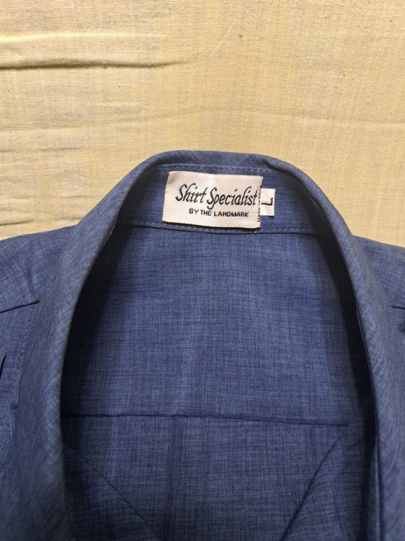 Cropped Polo (Large) (Category: Tshirts & Polo Shirts ) located in Manila. Submitted by sainty.exe (Listing ID 1463991687, Image 2). Description: - Blue short sleeve button up shirt - Brand: Shirt Specialists by The Landmark - Size: L - Features: Textured fabric, two buttons on the side hem - Ideal for: Casual wear.